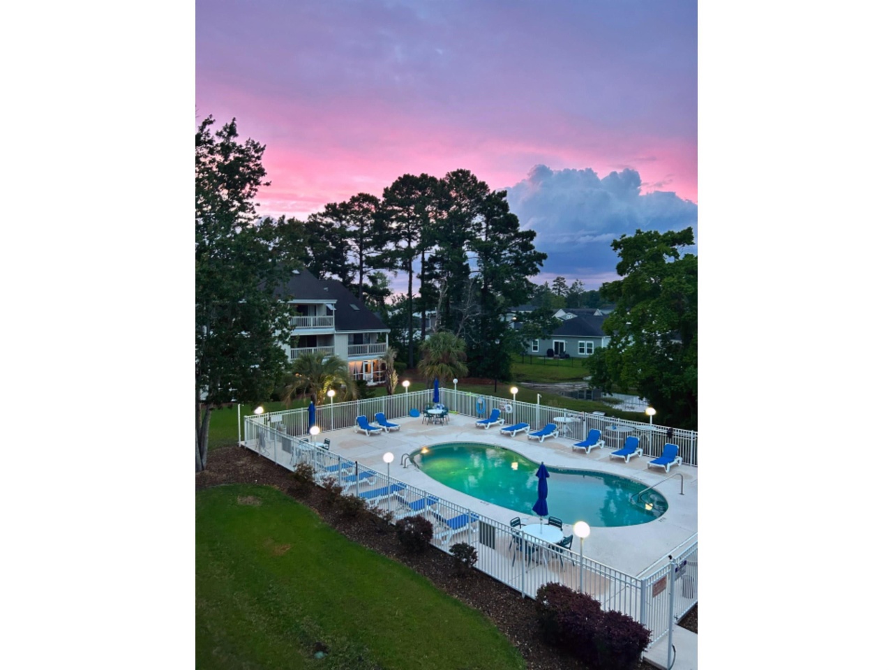 The Clubhouse at Golf Colony pool at sunset